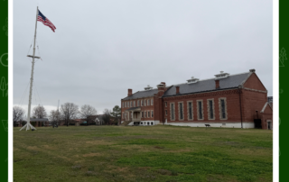 The barracks and courthouse building at Fort Smith National Historic Site, Arkansas, with the flag flying
