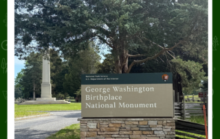sign at George Washington Birthplace with monument in the background