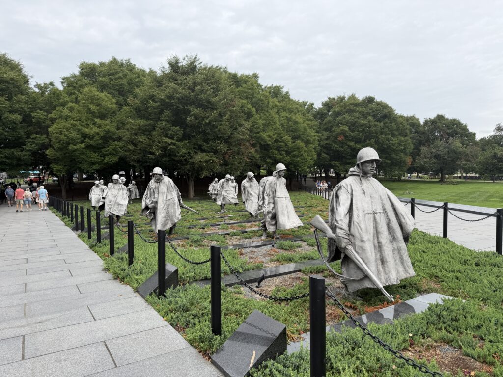KWM - soldiers walking The nineteen stainless steel soldiers of the Korean War Veterans Memorial moving through the field