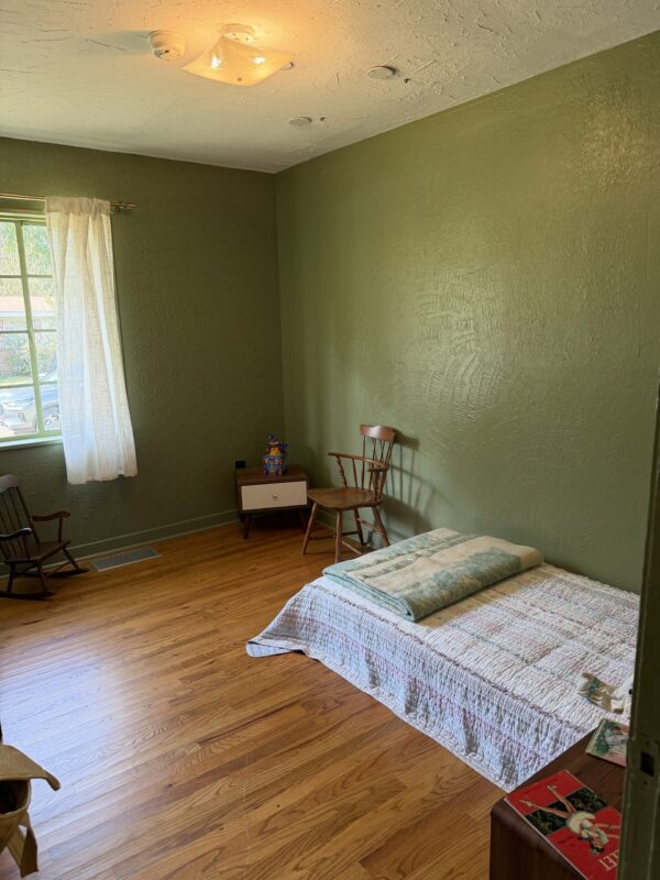 MME - kids bedroom The children's bedroom in the Evers home, with a mattress on the floor against green walls