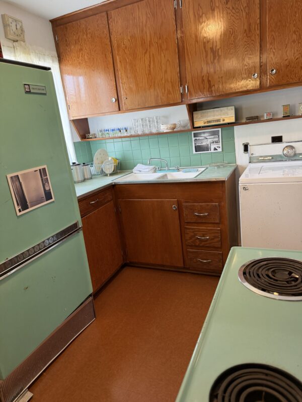 MME - kitchen The Evers family kitchen, with its original mint green stove and refrigerator and wood cabinets