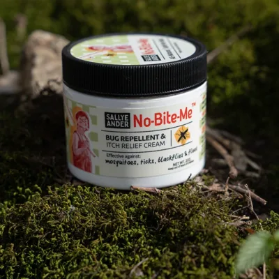 Jar of SallyeAnder No-Bite-Me cream sitting on moss