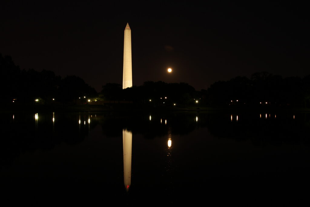 WAM - at night The Washington Monument lit at night with the moon beside it, both reflected in the still water below