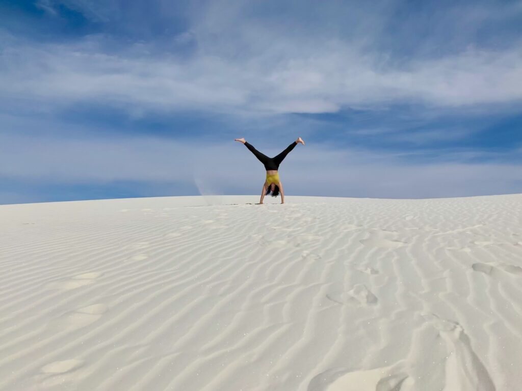 WSNP - cartwheel A cartwheel on a dune at White Sands National Park under a blue sky